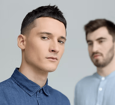 Two men staring into camera